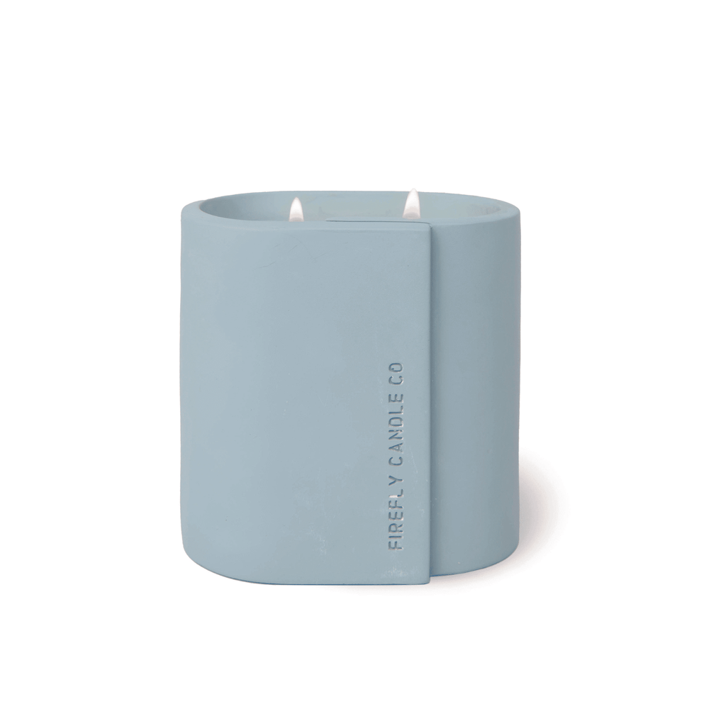 From the Cirque Collection by Paddywax, the Firefly - Azure Waters 12oz Candle features scented soy wax and two wicks in a modern, rectangular vessel embossed with Firefly Candle Co.