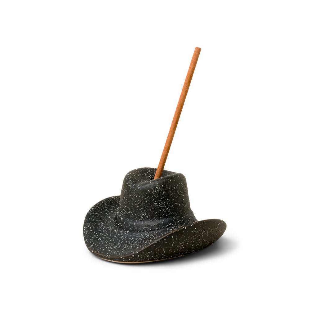 The Paddywax Black Cowboy Hat Ceramic Incense Holder exudes a Western vibe with its wide brim and rounded crown. Its perfect for centering an incense stick, like Palo Santo, ready to evoke soothing nostalgia.