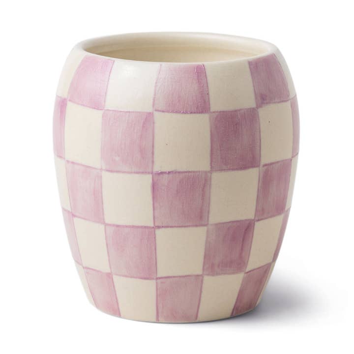 The Paddywax Checkmate Lavender Mimosa 11oz Candle features a hand-painted pink and cream checkerboard ceramic cup, perfect for reuse as a stylish vessel after enjoying the candle.