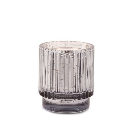 The Paddywax Cypress + Fir 4.5oz Small Candle features a cylindrical, silver mercury glass design with vertical textured lines and a grayish tint, softly reflecting light and adding a holiday fragrance to any space.