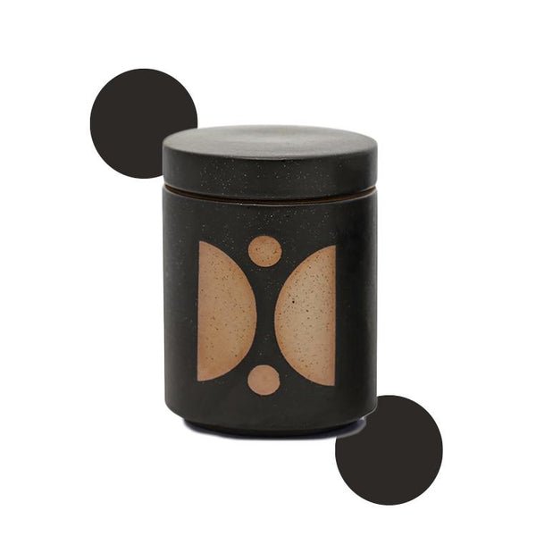 The Paddywax - Form Palo Santo Suede 12oz Candle by Paddywax is a dark ceramic cylinder with a fitted lid showing geometric designs in beige, featuring two opposing crescents flanked by dots and black circles on each side, making it a unique fragrance holder or candle planter.