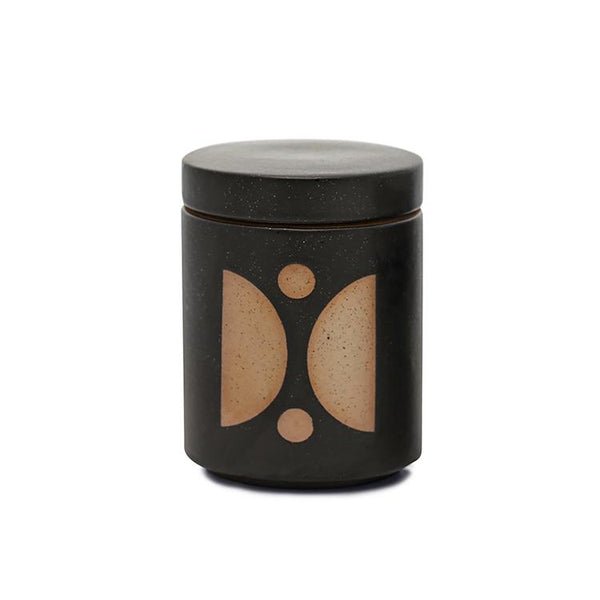 The Paddywax - Form Palo Santo Suede 12oz Candle features a cylindrical, dark ceramic vessel with a lid and minimalist tan semicircles and dots. Its matte finish enhances its modern look, making it ideal as a candle planter while subtly complementing the fragrance.