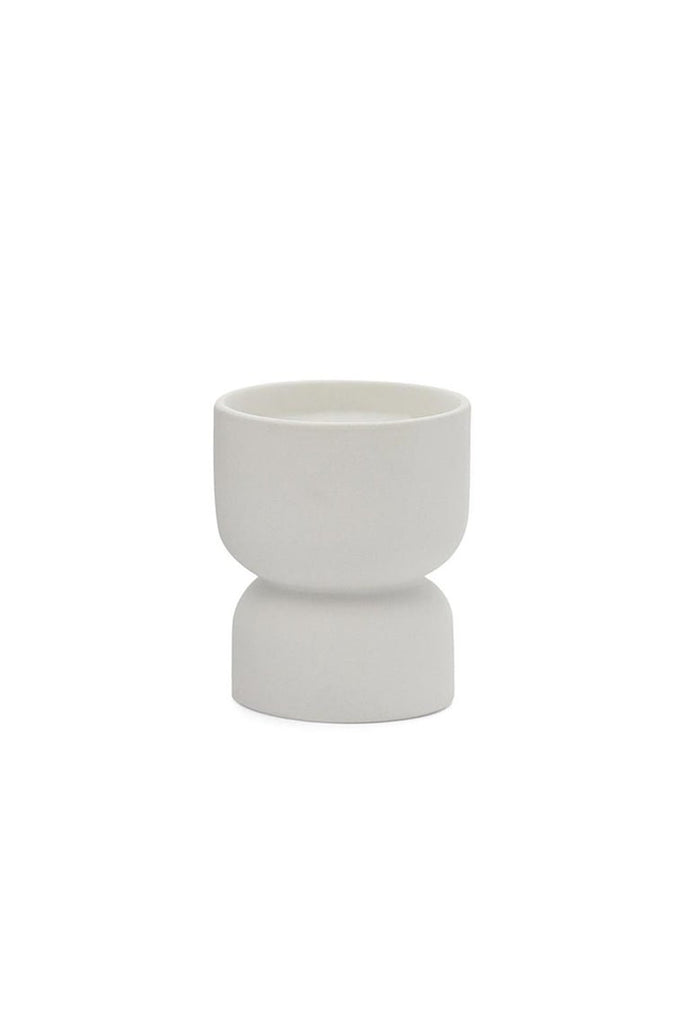 The Paddywax Form Tobacco Flower 6oz Candle is a chic, white ceramic planter-shaped candle with a minimalist hourglass design, featuring a wide top bowl and narrower base for an elegant effect.