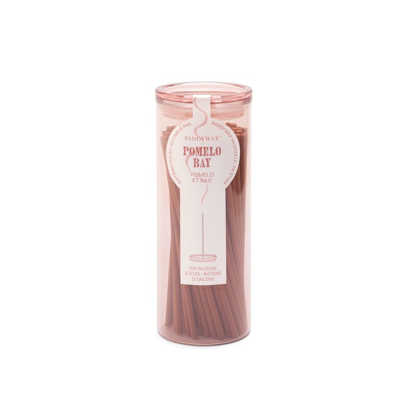 The Paddywax Haze - Pomelo Bay Travel Incense includes 100 incense sticks in a minimalist cylindrical container with a transparent package and pink lid, offering popular fragrances to elevate your space.