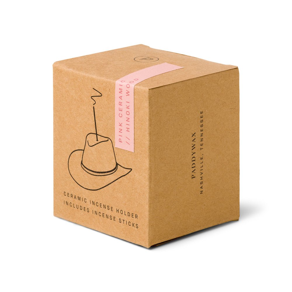 A brown cardboard box featuring a black minimalist cowboy hat illustration with a Western vibe, labeled Paddywax - Pink Cowboy Hat Ceramic Incense Holder, contains the unique cowboy hat incense holder and fragrant sticks by Paddywax, Nashville, Tennessee.