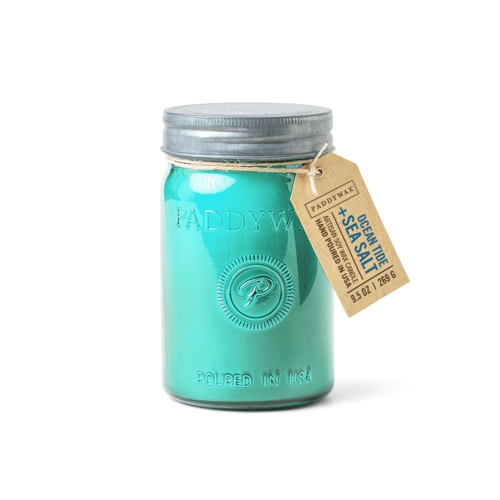 The Paddywax - Relish Ocea Tide + Sea Salt 9.5oz Candle features a charming embossed turquoise jar with metal lid and brown tag—enjoy a soothing scent, then upcycle the stylish storage jar.