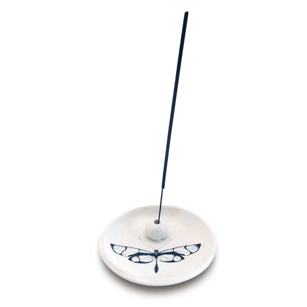 The Skeem Citronella Incense Holder is a handmade earthenware piece featuring a black butterfly on white, designed to hold a single incense stick at an angle—ideal as an outdoor incense burner for bug protection.