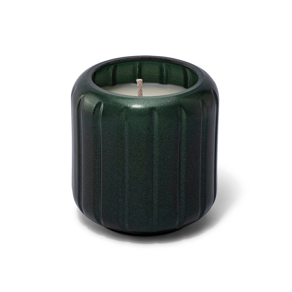 The Skeem Forest Green Candlescape 8 oz Candle, Teakwood Fir, features a stylish green ribbed holder with a white exposed-wick candle at its center. It adds an enchanting festive touch to your decor.