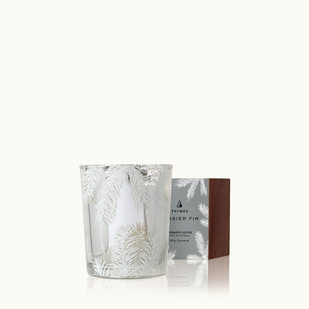 The Thymes - Frasier Fir Statement Boxed Votive 2oz Aromatic Candle features silver pine branch decor in a glass holder, a wood-texture lid box, and brings the fresh scent of Siberian Fir to your space.