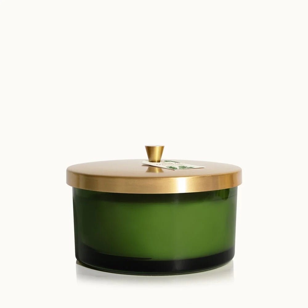 The Thymes Frasier Fir Green 4-Wick Candle features a green glass jar with a gold metal lid and small gold knob, shown against a plain white background.