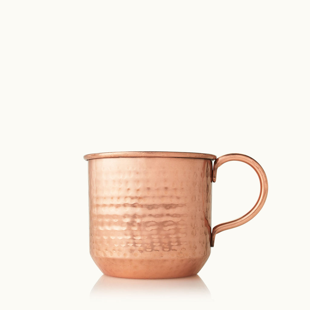 The Thymes Shimmered Cider Copper Mug 10oz Aromatic Candle features a hammered copper mug with a handle, displayed against a plain white background.