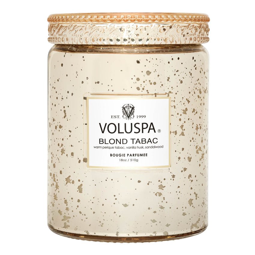 The Voluspa Blond Tabac Large Jar 18oz Candle offers a luxurious blend of Perique tabac, vanilla husk, and sandalwood in a decorative speckled gold glass jar with a textured lid, crafted from premium coconut wax.