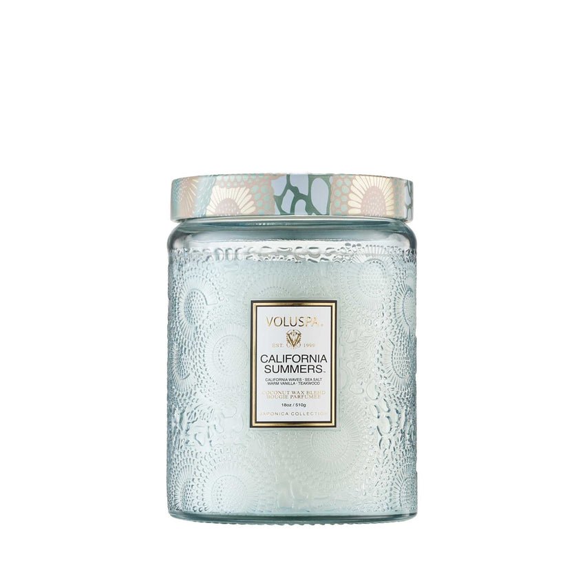 The large Voluspa California Summers candle features a coconut wax blend with lemon, wood, and sea salt in a textured pale blue glass jar with a decorative lid.