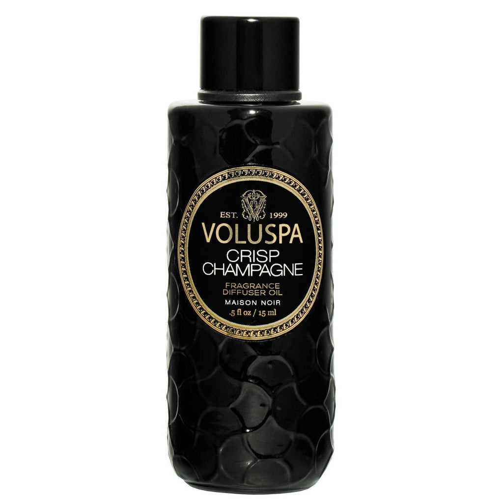 Voluspa - Crisp Champagne Ultrasonic Diffuser Oil is a black textured bottle with gold trim and a stylish black and beige label. The 15 oz capacity ensures a luxurious aromatic experience.