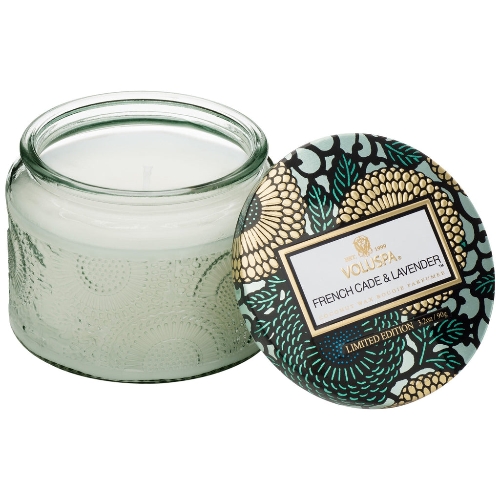 The Voluspa French Cade Lavender Petite 3.2oz Jar Candle features a luxurious coconut wax blend in off-white. Its lid showcases a gold and black design with green and beige accents, while a label reads Voluspa French Cade & Lavender Limited Edition.