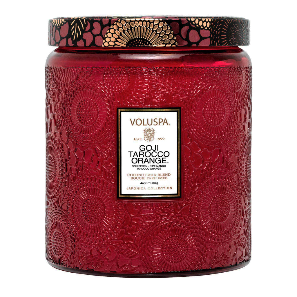 The Voluspa Goji Torocco Orange Luxe Jar 44oz Candle features a red floral textured design with a luxurious coconut wax blend. The black and gold lid has intricate details that complement the goji berry scent.