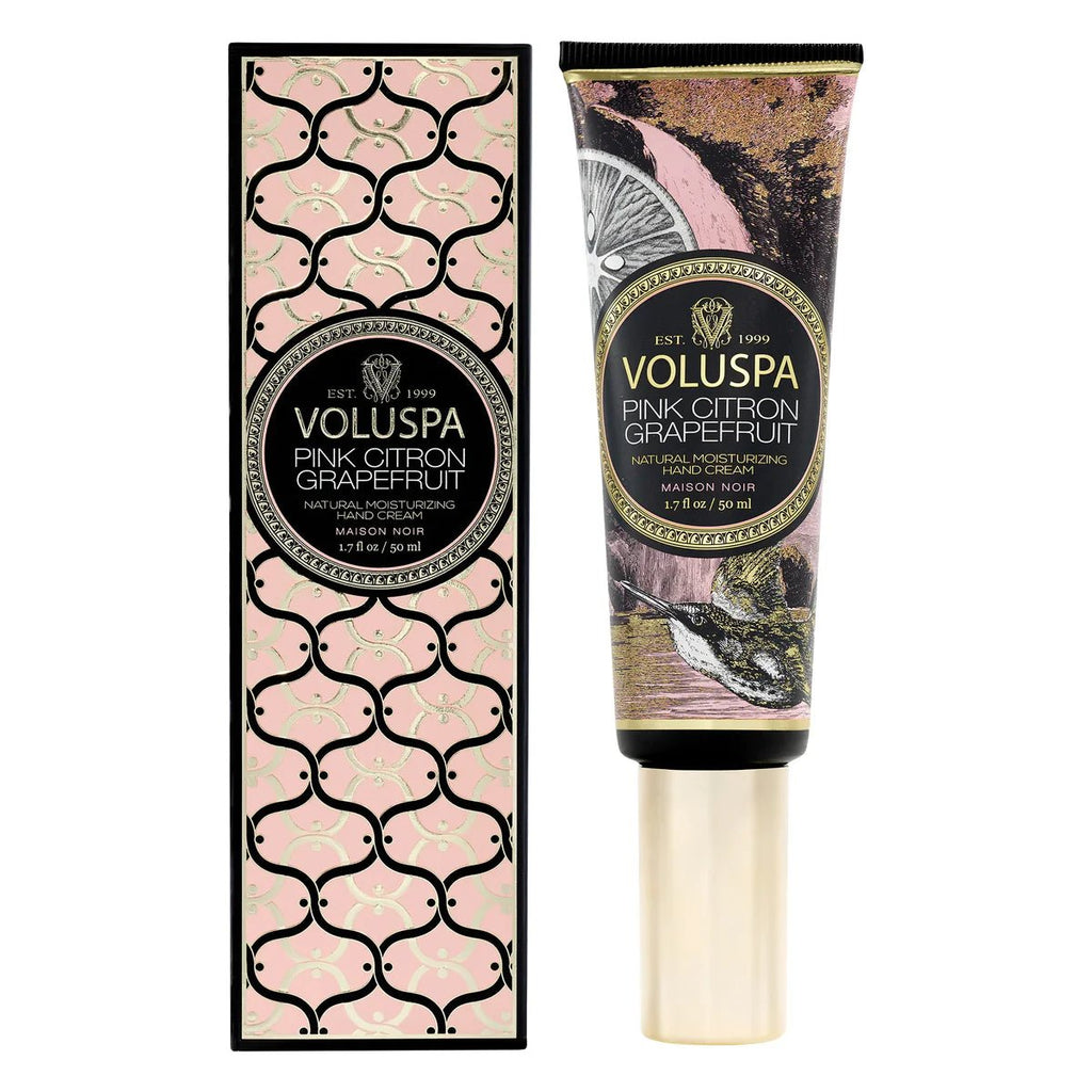 Voluspas Pink Citron Grapefruit Natural Moisturizing Hand Cream, with its distinct moisturizing formula, is packaged in a pink and black geometric box. The tube showcases ornate illustrations with a gold cap, highlighting the essence of grapefruit.