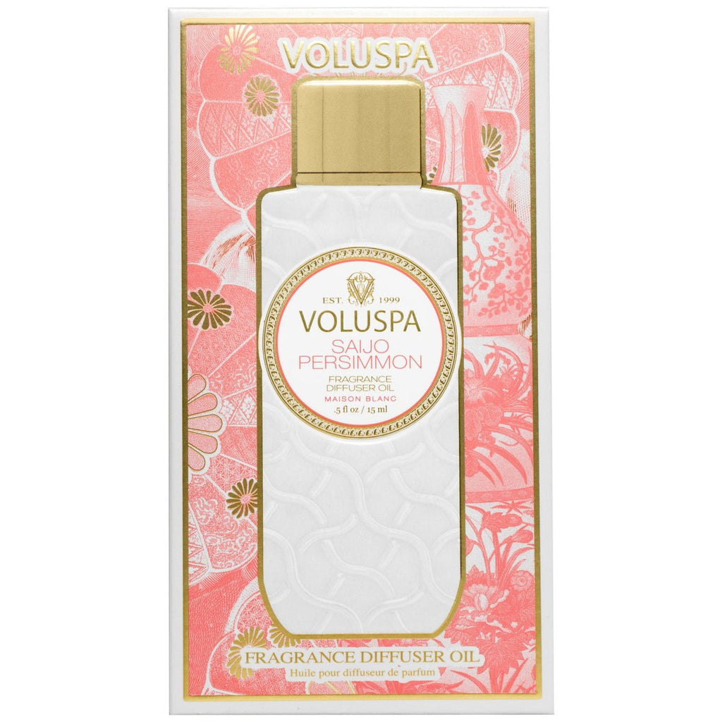 The Voluspa Saijo Persimmon Fragrance Ultrasonic Diffuser Oil is beautifully packaged with floral and fruit designs in pink and gold. The bottle has a decorative white and gold pattern, featuring the brand name prominently, offering a touch of jasmine allure.