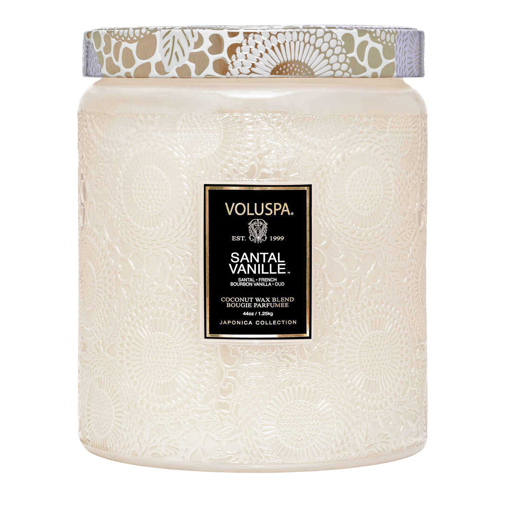 The 44oz Voluspa - Santal Vanille Luxe Jar Candle from the Japonica Collection features an intricate floral glass design and a coconut wax blend with captivating santal and vanilla notes.