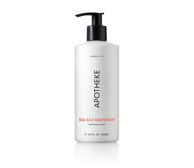 Apotheke Sea Salt Grapefruit lotion comes in a white 10 fl oz (300 ml) bottle with a black pump, showcasing Brooklyn, NY, Sea Salt Grapefruit, and Plant-Based Lotion infused with natural botanicals on the label.