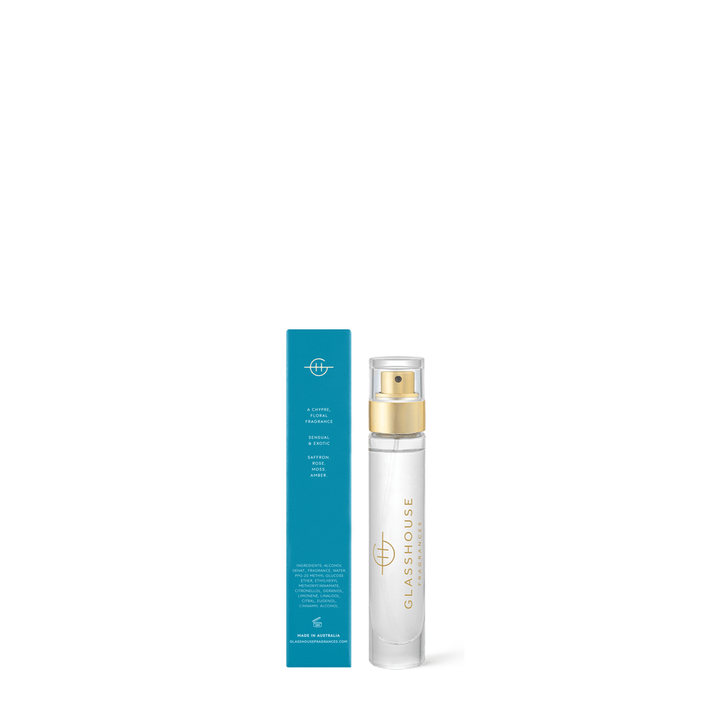 A clear 14ml Glasshouse Fragrances - Eau de Parfum Midnight In Milan bottle with a gold spray top stands upright beside its blue rectangular box, both positioned against a white background.