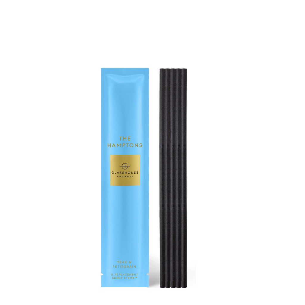 Experience the refreshing Teak & Petitgrain aroma of Glasshouse Fragrances The Hamptons Scent Stems in blue packaging with a black ribbed container.